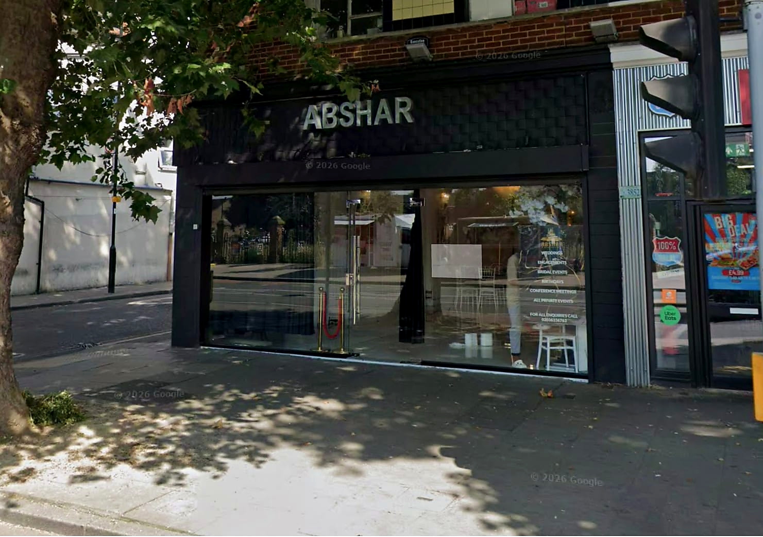 The Abshar front in daytime, with the name in metal letters above the glass doors